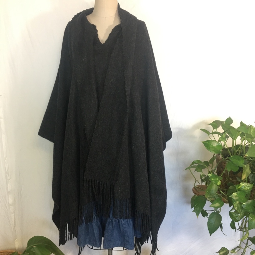 TUMI alpaca fringed poncho in a dark charcoal gray